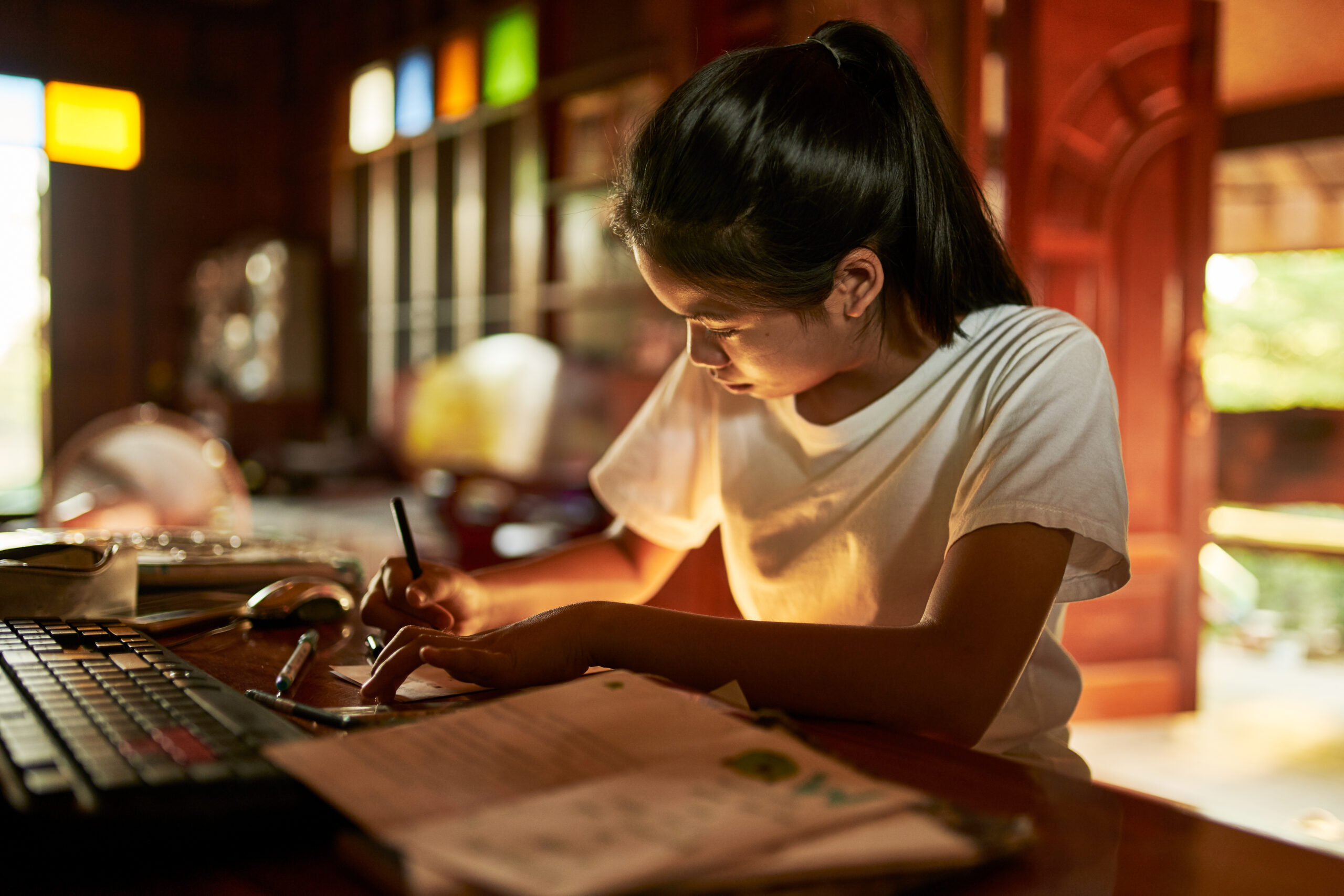 thai teen girl doing homework and studying at home